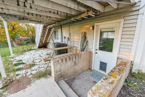 Doorway to property with a patio area
