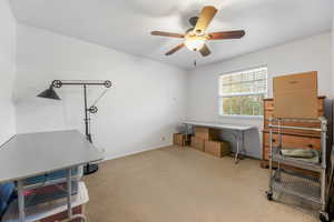 Misc room featuring light colored carpet and ceiling fan
