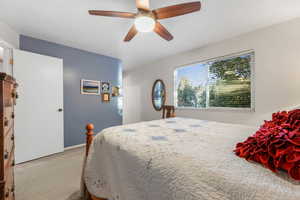 Bedroom with light carpet and ceiling fan