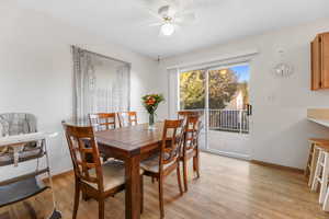 Dining space featuring light wood-style flooring and ceiling fan