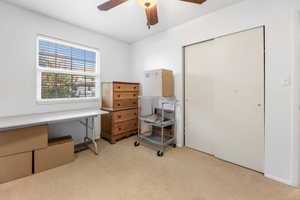 Office featuring light colored carpet and ceiling fan
