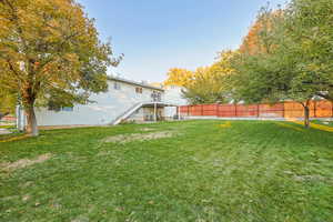 Fenced backyard featuring stairs