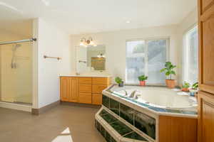 Master bath featuring a large jetted tub, double vanity and walk-in shower.