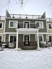 View of front of home with a balcony and a patio