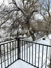 View of snow covered back of property