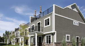 View of property exterior with stone siding and a balcony
