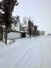 Snow covered property featuring board and batten siding