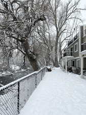 Snowy yard featuring a balcony