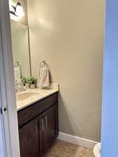 Bathroom featuring light tile patterned flooring and vanity