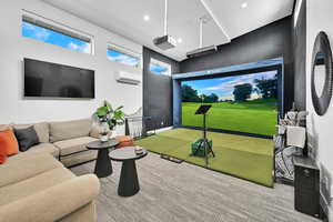 Playroom with golf simulator, carpet floors, view of golf course, recessed lighting, and a wall unit AC