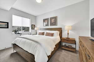 Carpeted bedroom featuring baseboards