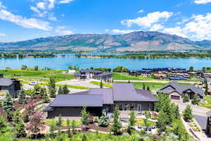 Aerial view of property and surrounding area with a water and mountain view