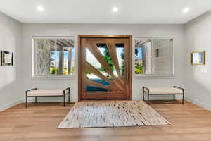 Foyer with light wood-type flooring and recessed lighting