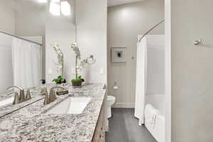 Bathroom with vanity and shower / bathtub combination with curtain