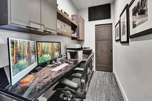 Office with built in desk and light colored carpet