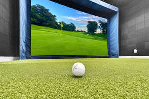 Recreation room featuring golf simulator and view of golf course