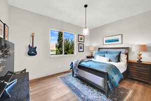 Bedroom with wood finished floors and baseboards
