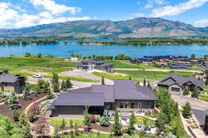 Aerial view of property and surrounding area featuring a water and mountain view