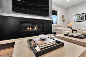 Living area featuring a glass covered fireplace