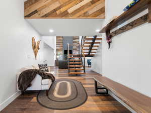 Living area featuring dark wood-style flooring, stairway, and recessed lighting