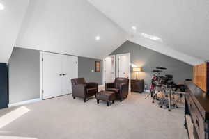 Bedroom 3, with light colored carpet, vaulted ceiling, and recessed lighting