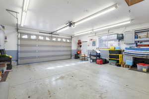 Heated, Detached 2 Car Garage featuring a garage door opener and electric panel