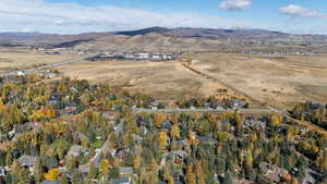 Aerial view of property and surrounding area with a mountain backdrop