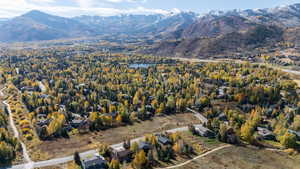 Aerial overview of property's location featuring a water and mountain view