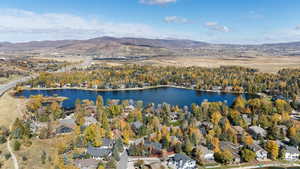 Aerial overview of property's location with a water and mountain view and nearby suburban area