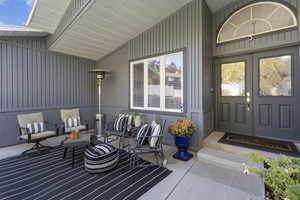 View of exterior entry with a patio area