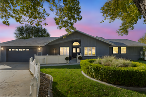 Ranch-style house with driveway, roof with shingles, and an attached garage