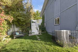 View of home's exterior featuring stairs and a wooden deck