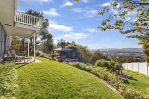 View of yard with a patio, a gazebo, a mountain view, and a balcony