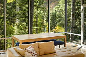Sunroom featuring a wooded view