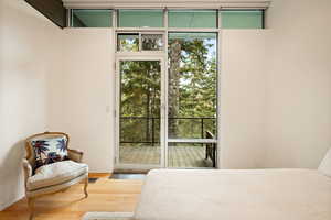 Bedroom featuring wood finished floors and access to exterior