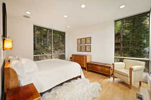 Bedroom with recessed lighting, light wood-style flooring, and floor to ceiling windows