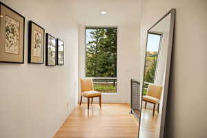 Living area with light wood-style flooring and recessed lighting