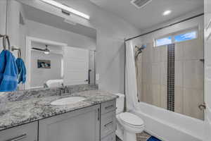 Bathroom featuring shower / bath combo with shower curtain, vanity, ensuite bath, recessed lighting, and ceiling fan