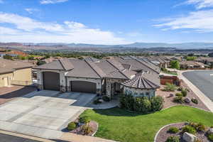 View of front of property with a residential view, an attached garage, stucco siding, and stone siding