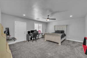 Bedroom with a desk, light colored carpet, a ceiling fan, recessed lighting, and a textured ceiling