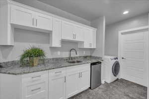 Kitchen with white cabinets, light carpet, washer / clothes dryer, light stone counters, and recessed lighting