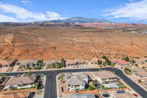 Aerial view of property and surrounding area with a mountainous background