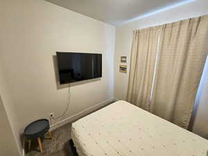 Carpeted bedroom featuring baseboards