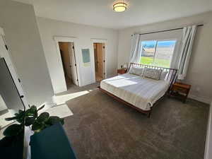 Bedroom with carpet floors and ensuite bath