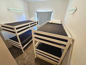 Bedroom featuring dark colored carpet