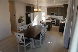Dining area with light wood-style floors and baseboards