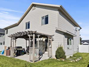 Back of house featuring a pergola, and a patio.