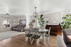 Dining space featuring light wood-style flooring and arched walkways