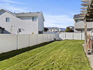Fenced backyard featuring a mountain view