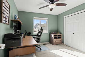 Office with carpet floors and ceiling fan